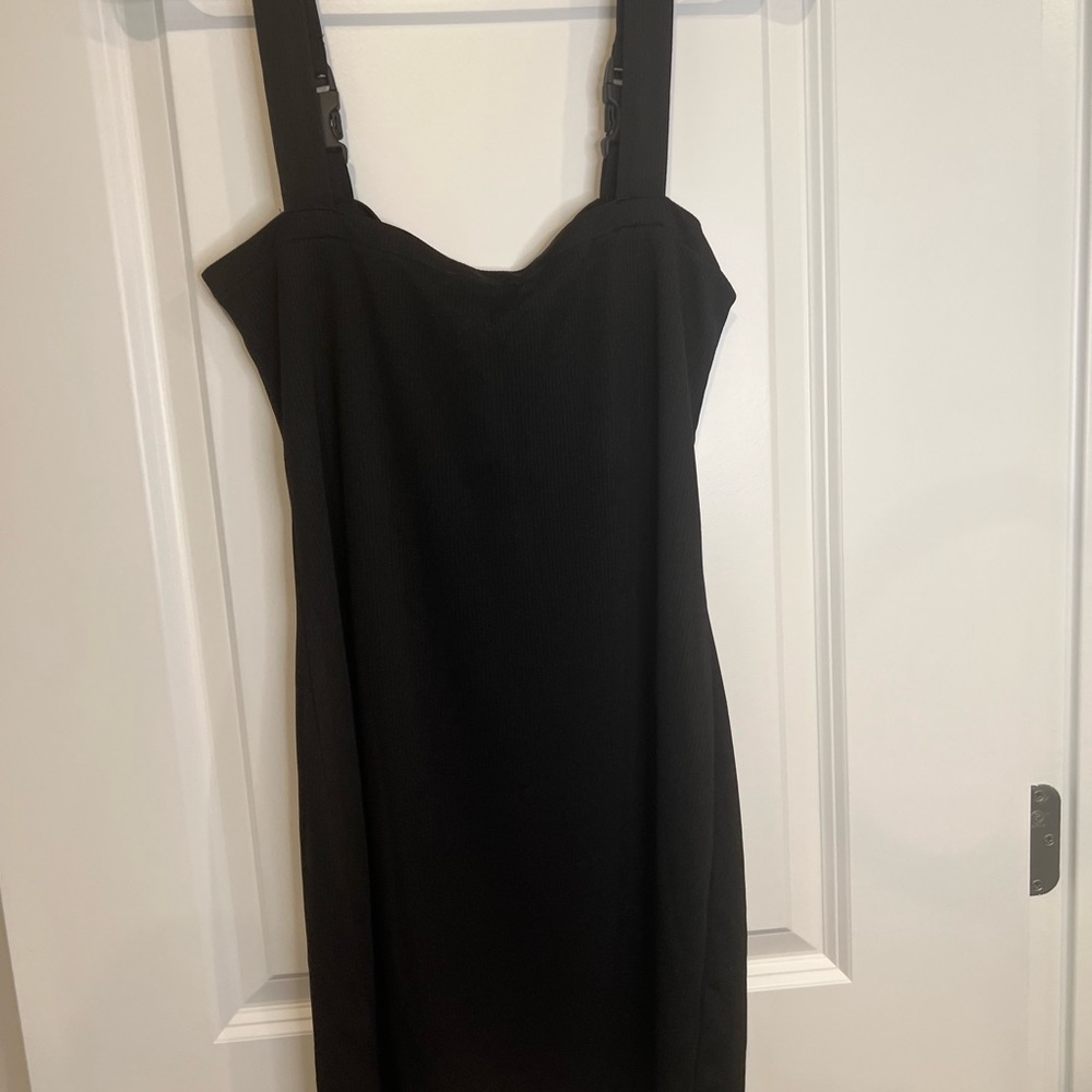 Black mini dress. With buckle front straps. Size medium
